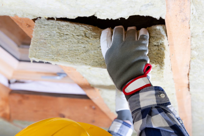 Man,Installing,Thermal,Roof,Insulation,Layer,-,Using,Mineral,Wool