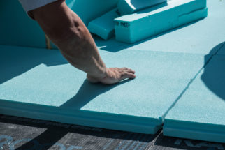 Worker,Placing,Xps,Polystyrene,Insulation,Boards,On,The,Flat,Roof.